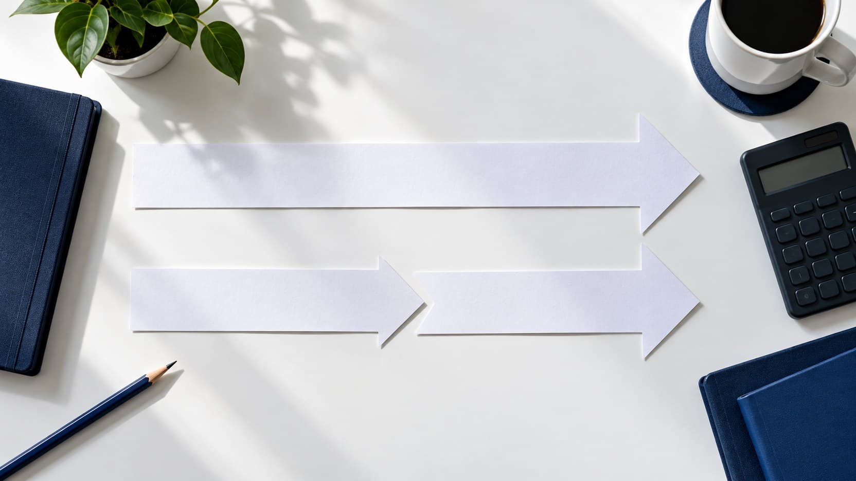 Two blank paper strips showing separate investment paths beside a financial calculator on a white desk.